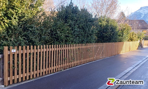 Staketen Holz vor die Pfosten / Lärchenkantpfosten braun eingerammt wurde in Interlaken von Zaunteam Berner Oberland, Ringgenberg im Jahr 2026 erstellt.