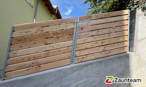 Sichtschutz aus Bohlen mit Zwischenraum mit U-Stahl Profil Pfosten wurde in Visp von Zaunteam Wallis, Niedergesteln im Jahr 2026 erstellt.